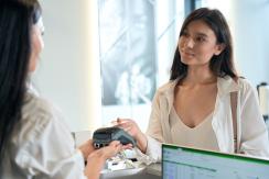 Frau bezahlt mit Karte in der Apotheke